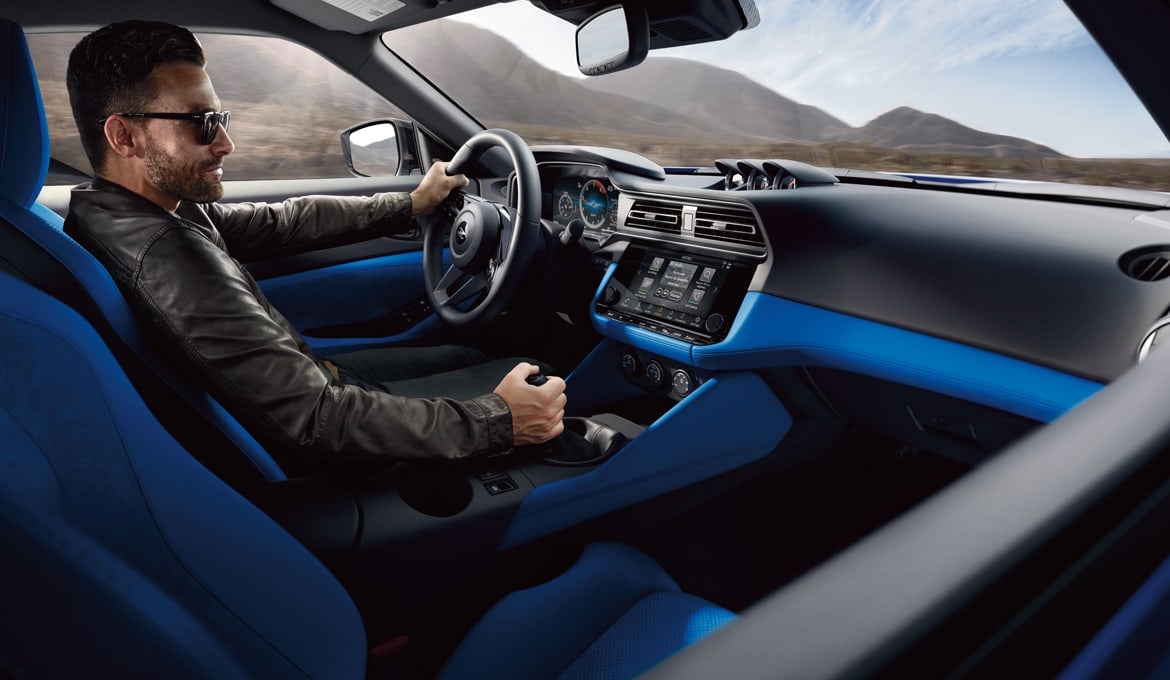A person driving a 2024 Nissan Z with blue interior