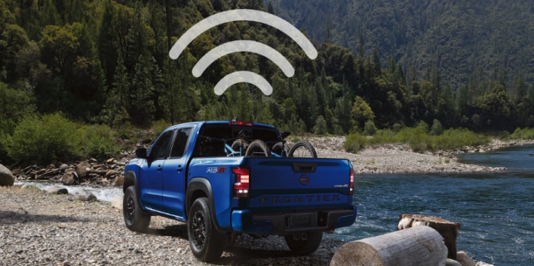 Wifi symbol hanging over a blue 2024 Nissan Frontier to illustrate the truck's wifi hotspot capabilities