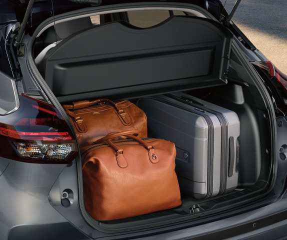 2024 Nissan Kicks rear view of open trunk with luggage highlighting trunk space cargo capacity 