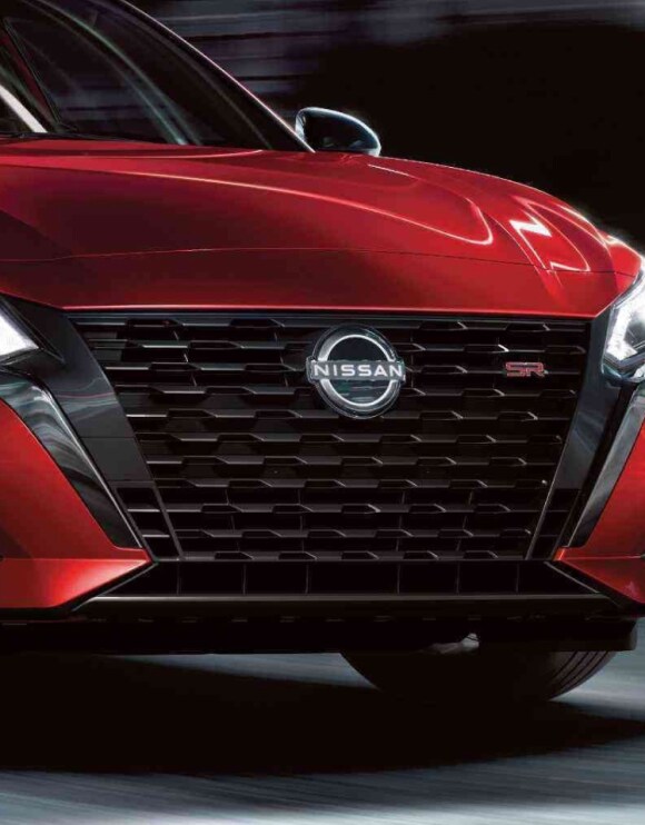 Zoomed in image of V-Motion Grile on red 2024 Nissan Altima
