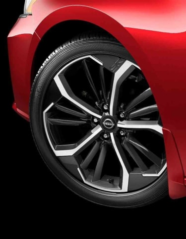 Zoomed in image of 19 inch Machine Finished Aluminum Alloy Wheels on red 2024 Nissan Altima