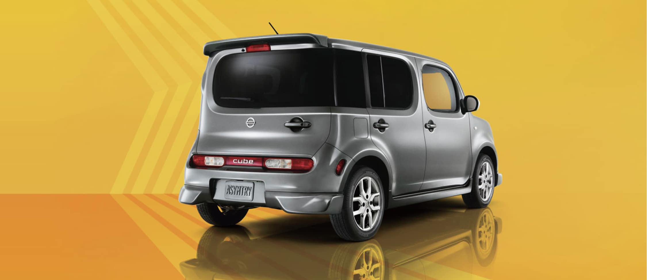 Rear view of Nissan Cube on yellow background