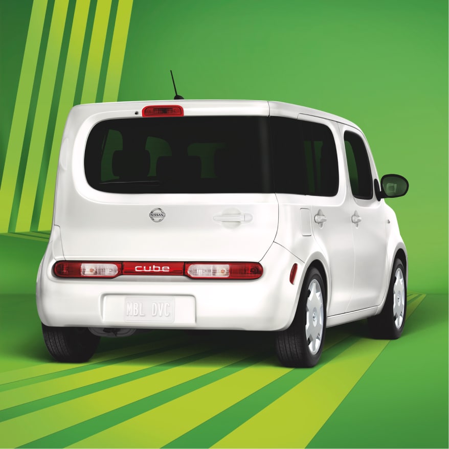Rear view of Nissan Cube exterior on green background