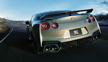  2024 Nissan GT-R rear view driving through well-lit tunnel.