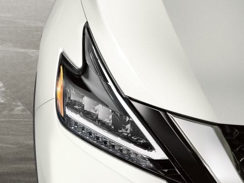 Close up of a white 2024 Nissan Murano LED headlights and daytime running lights 