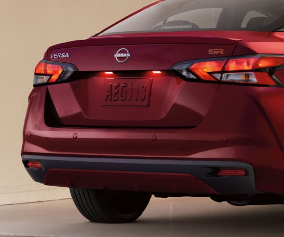 exterior view of red 2024 Nissan Versa signature taillights