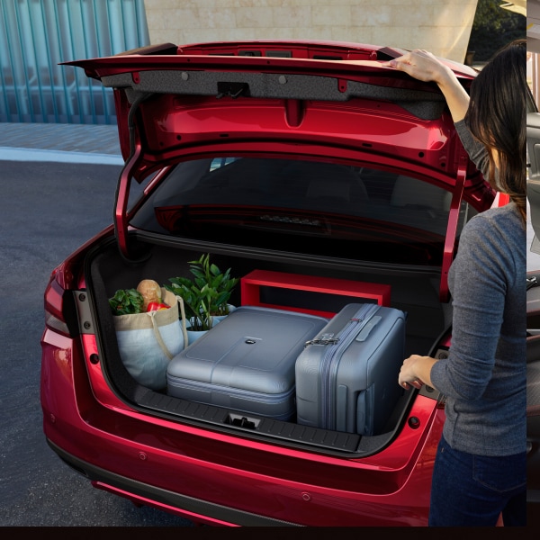 exterior view of red 2024 Nissan Versa trunk space with groceries
