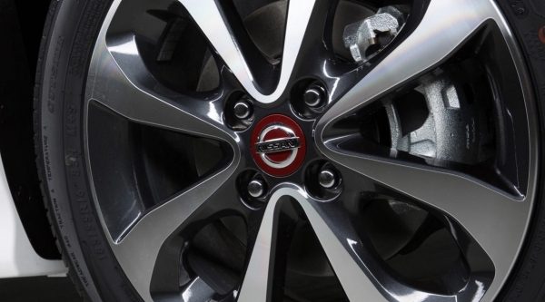 A close up of the red logo details of the Nissan Micra rims and bolt pattern
